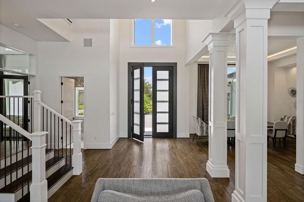 This view of the great room gives you appreciation for the well designed floor plan. Powder guest 1/2 bath to the left of the front doors, office via French doors and beautiful hardwood stairs leading to the 2nd level.