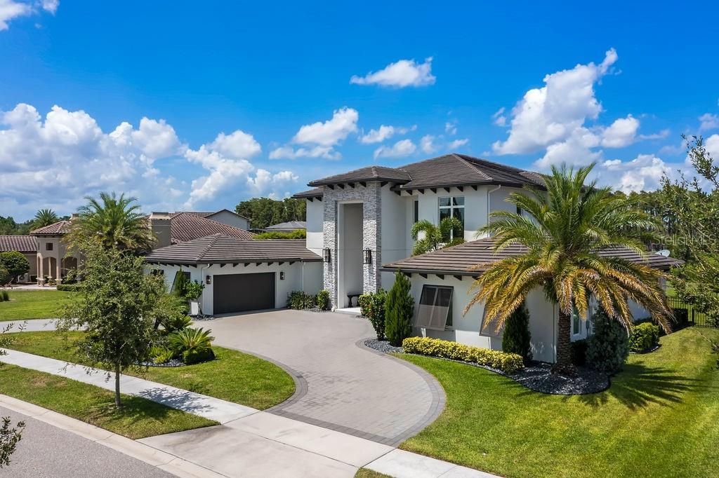 Extra wide circular drive allows for cars to easily pass each other and ease of in and out from either of the garage entrances.