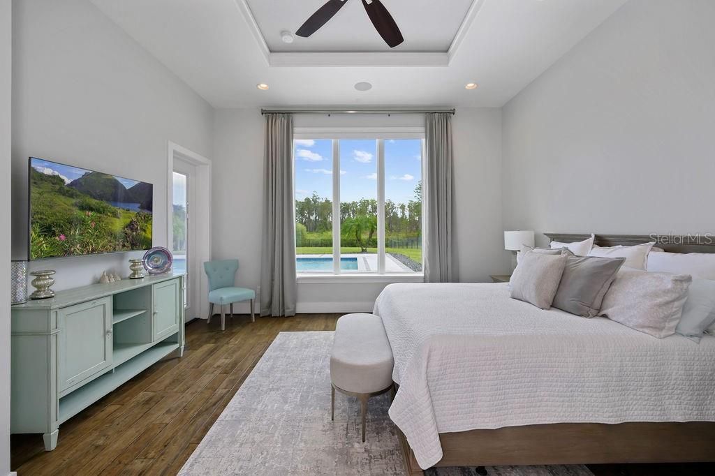 First floor master ( the estate also has a master upstairs) has an en suite bathroom. View of pool and immediate access to covered lanai allow flexibility for guests to have privacy and their own entrance.
