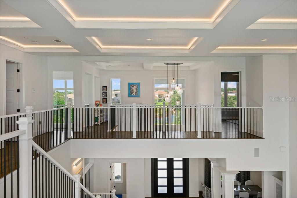 Upon ascending the stairs you are greeted to the second story surround, tons of natural light, a beautiful view of the pool and property and access to all the second story bedroom suites.