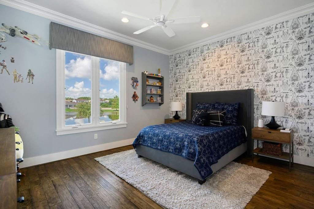 Bedroom 4 is oversized at 15'4" x 12'6" in size and features crown molding, ceiling fan and engineered wood floors.