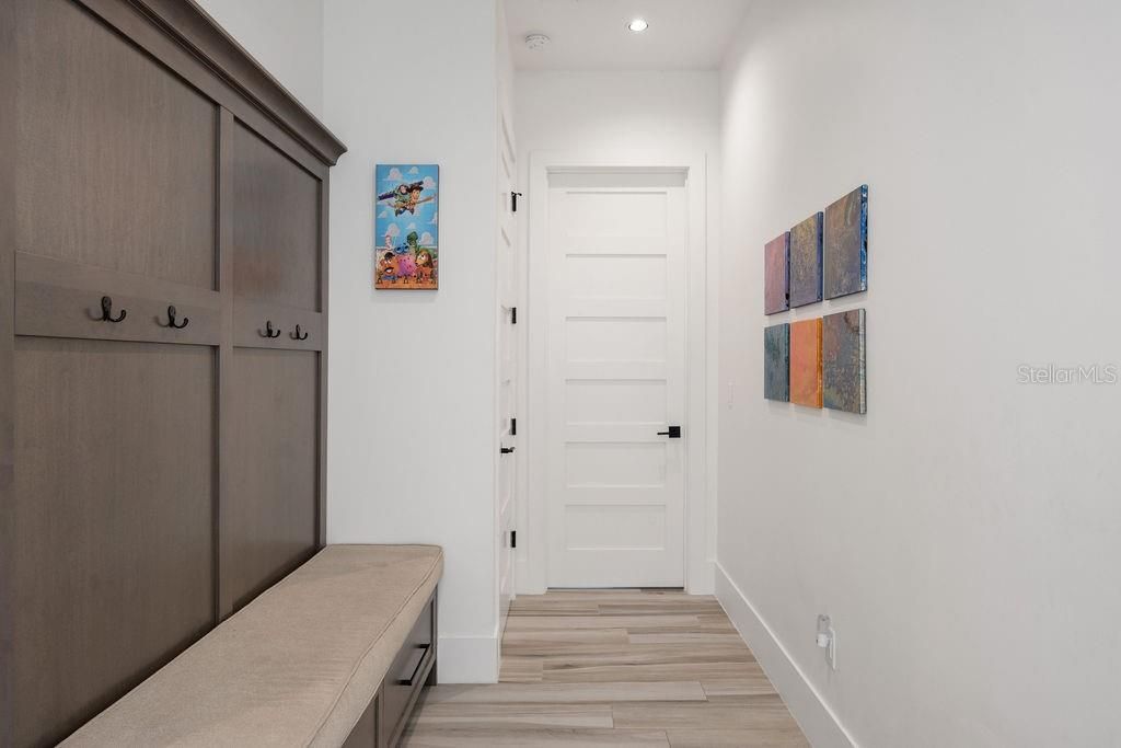 Hallway to the 2 car garage is complimented by a drop zone great for back packs, shoe change and built in storage drawers.