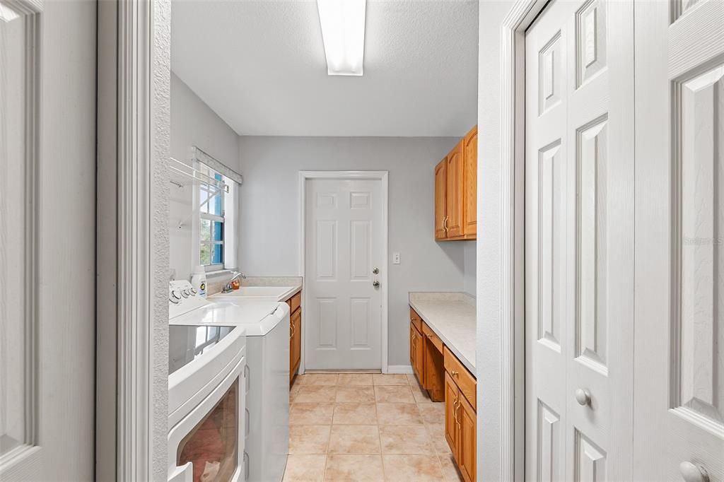 Laundry room with utility sink and cabinetry