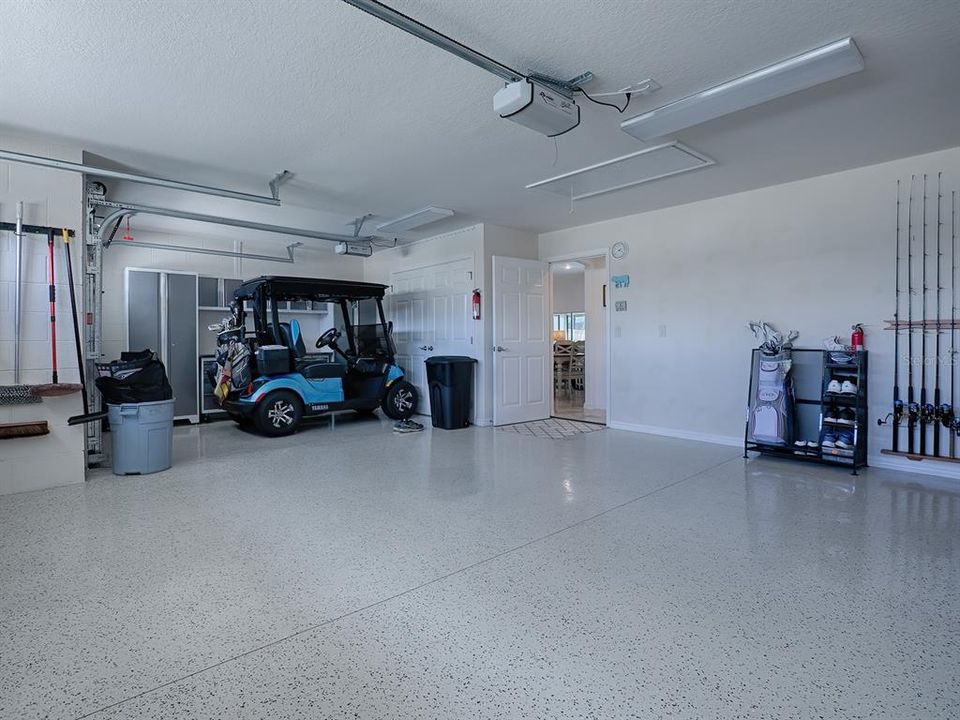 GARAGE WITH ATTIC STAIRS AND GOLF CART GARAGE WITH EXTRA ROOM BEHIND CART FOR OTHER STORAGE, BICYCLES, ETC.