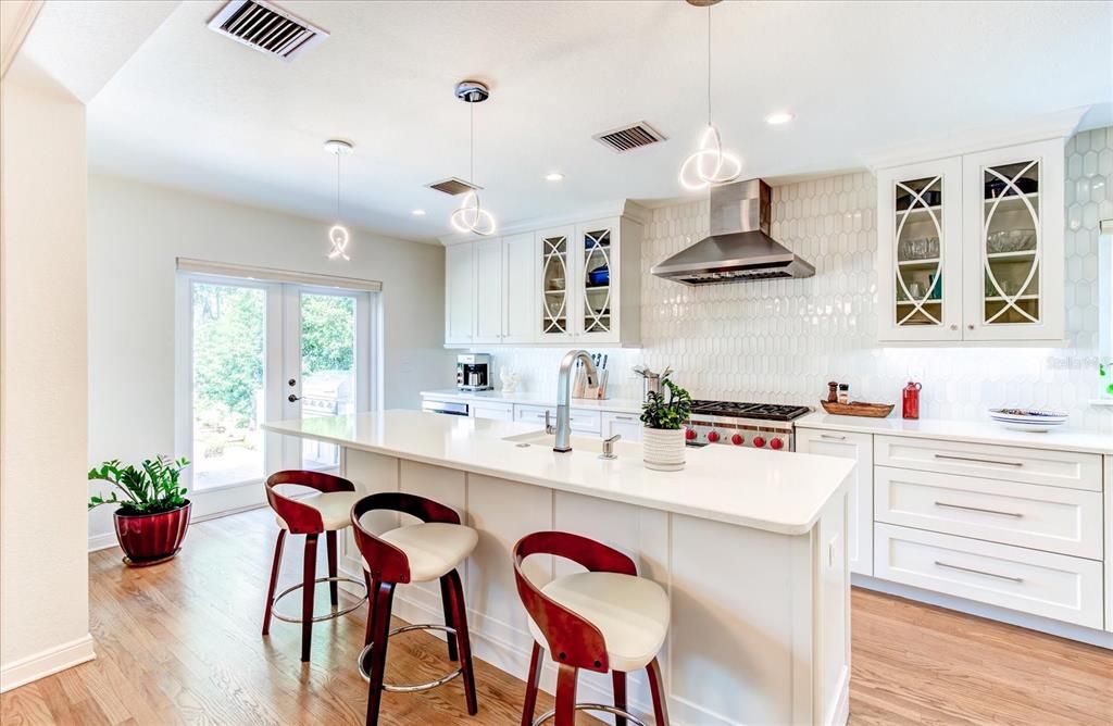 Chef's kitchen with bar seating and view of lake.