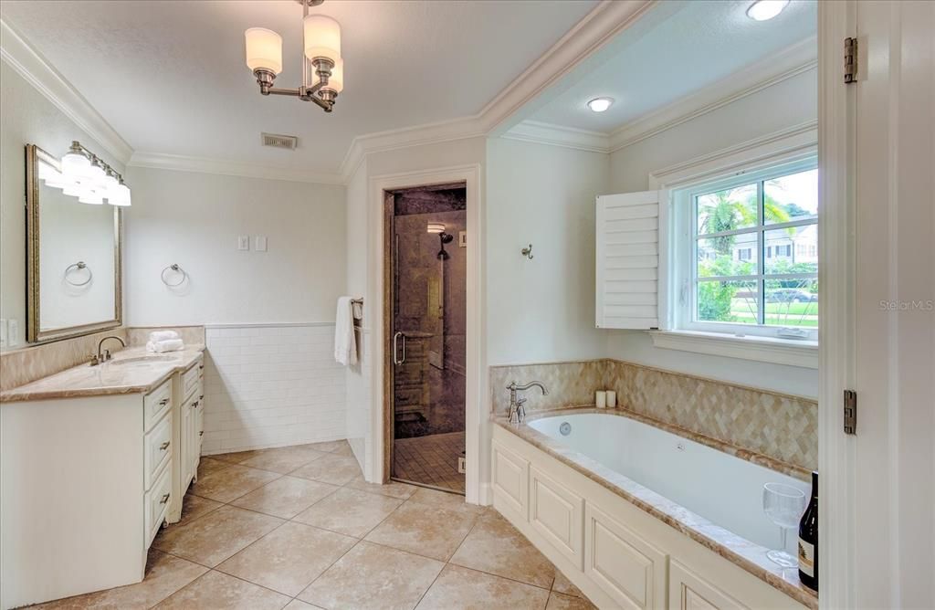 Separate sinks and plantation shutters on windows.
