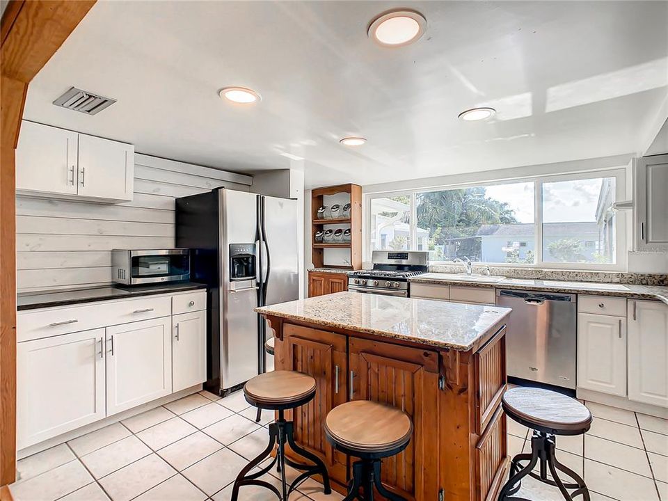 Large open kitchen offers center island and granite countertops.