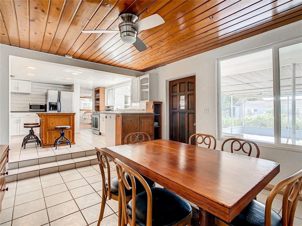 Dining room opens to the kitchen and the back door opens to the large screened lanai.