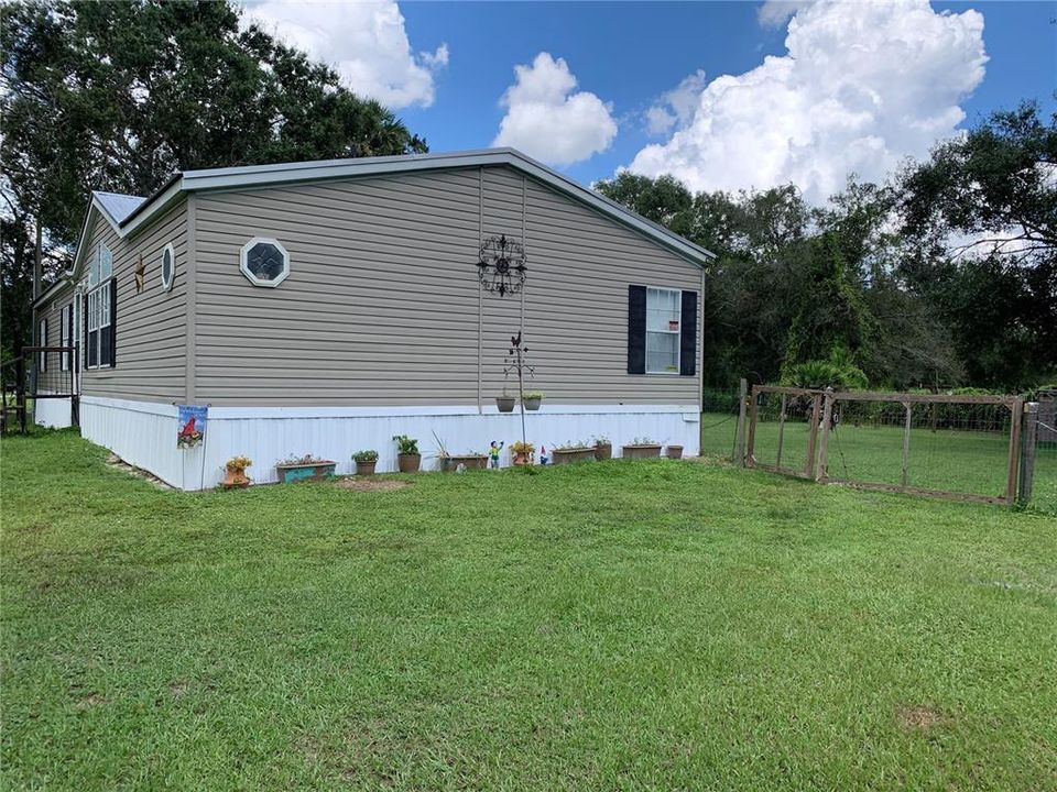 Side of home and  fenced in yard