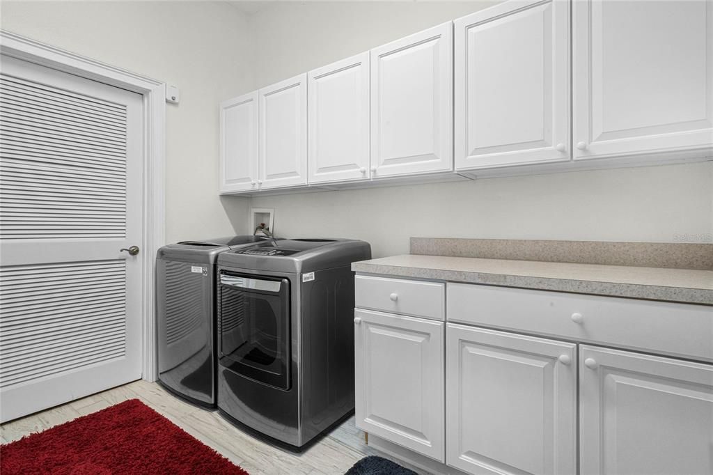 Laundry room with storage cabinets & folding table