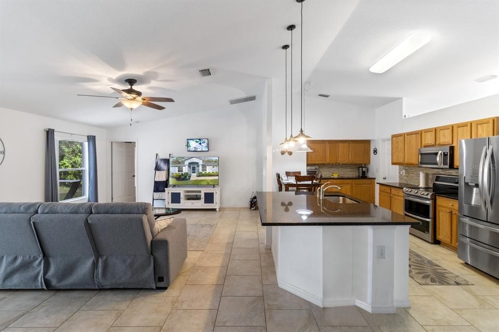 Family Room/Kitchen Combo w/ Vaulted Ceiling & Tile Floor