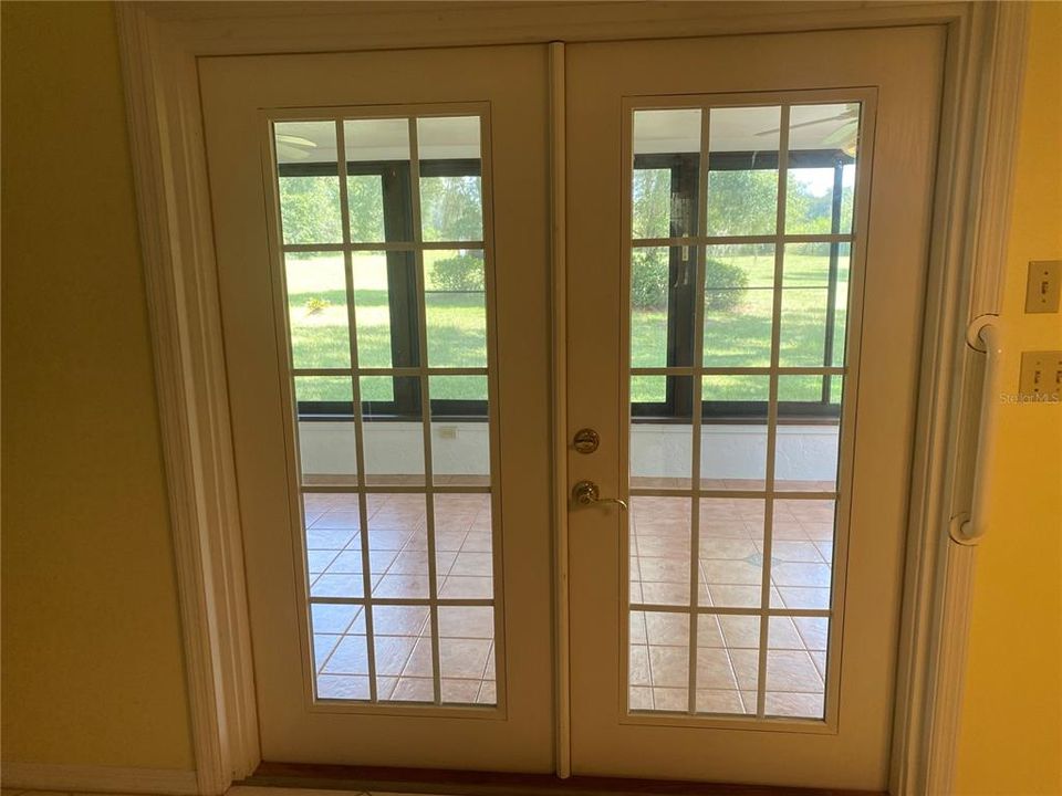 French doors from dining room to sunroom
