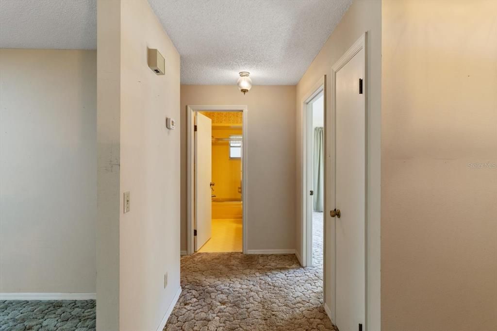 Hallway off Foyer Leads to Bedrooms 2 & 3 and Guest Bathroom ...Coat Closet is First Door on Right