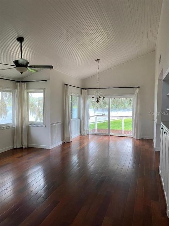 From front door the lake view can be seen through the Living room and Dining room windows as well as the sliding glass doors leading to the deck. Beautiful laminate flooring flowing throughout and cathedral ceiling in the Living and Dining rooms as well as the Master bedroom.