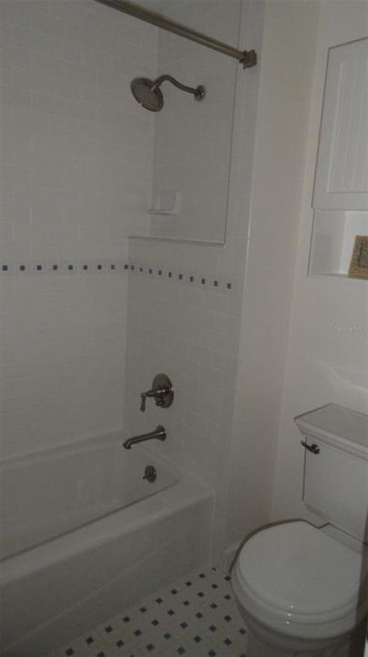 2nd Master bedroom has en-suite bathroom with combination shower & tub and commode separate from the vanity area.