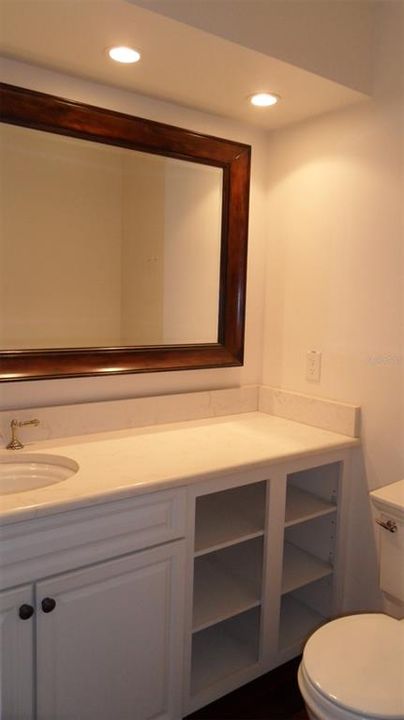 Overhead lighting and large mirror to compliment this half bath en-suite to the 3rd bedroom.