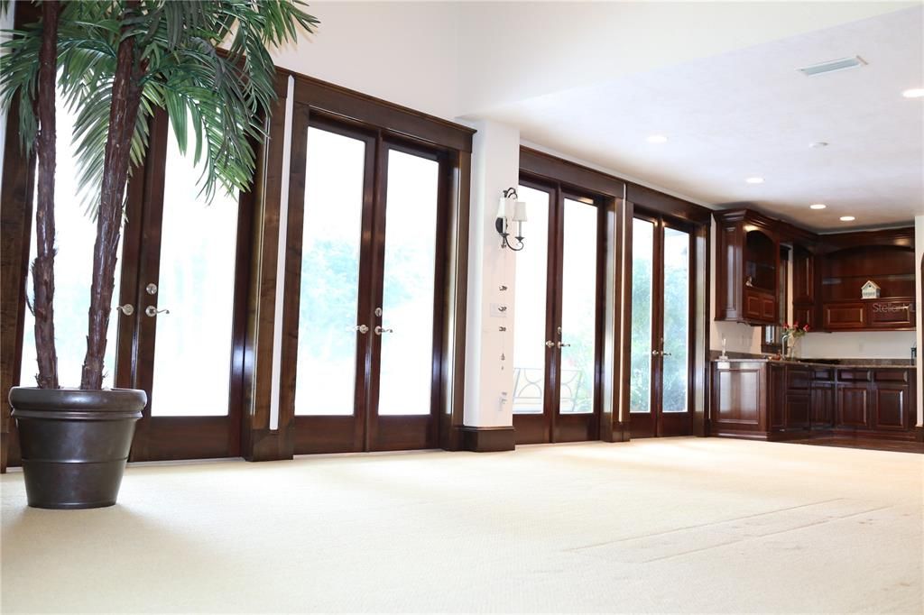 Second Wet Bar with French Doors leading to Covered Lanai and Pool