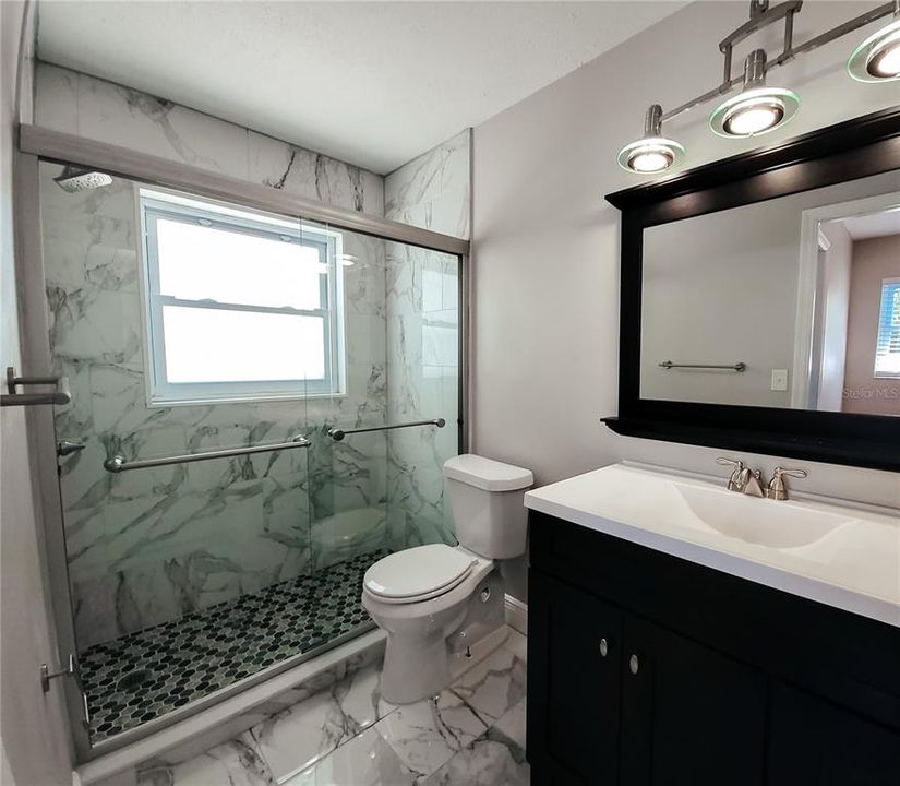 with ensuite bath beautifully updated with new vanity, mirror, fixtures, tiling, etc....
