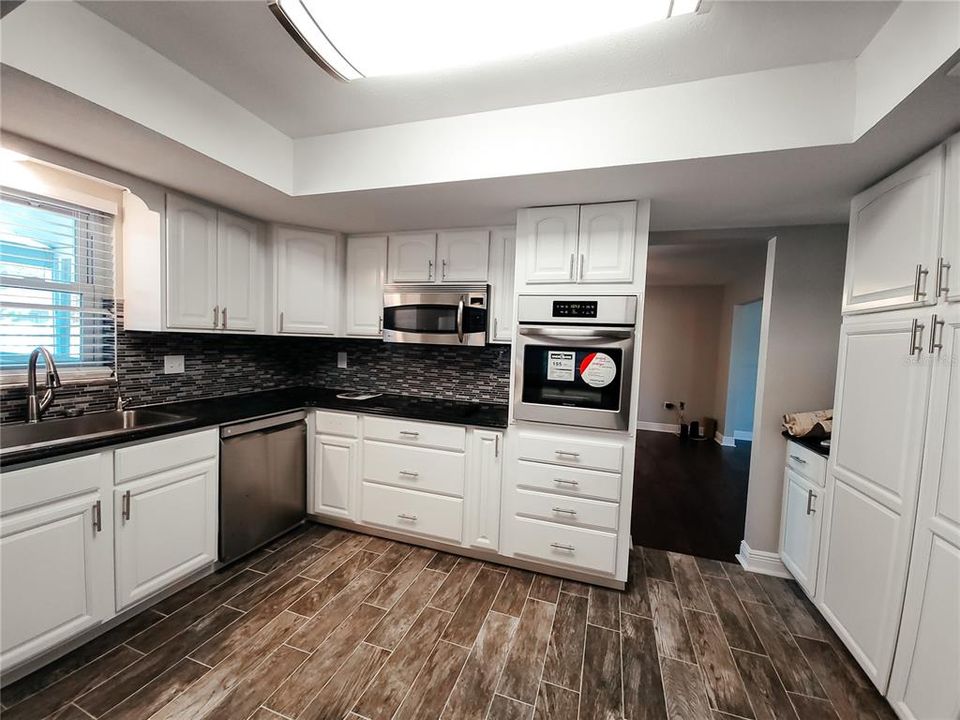 Cabinetry includes a pantry cabinet to the left of the side by side refrigerator