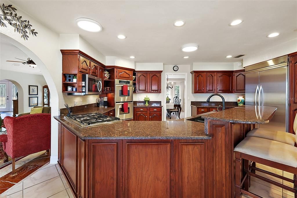 Abundant cabinetry, Granite countertops and breakfast bar