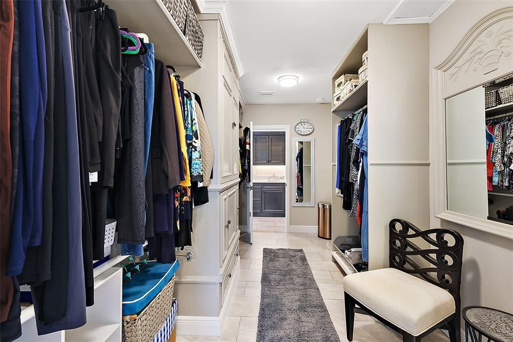 Owner's closet with passthrough to enter wet bar/personal laundry closet