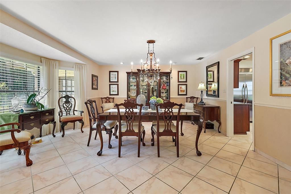 Formal dining room with large windows that overlook the property's beautiful front view