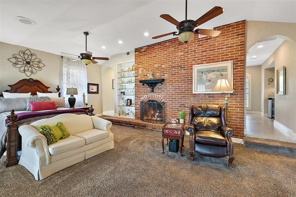 Brick walled fireplace adds a cozy feel. Note the entrance to the private wet bar and laundry closet to the right