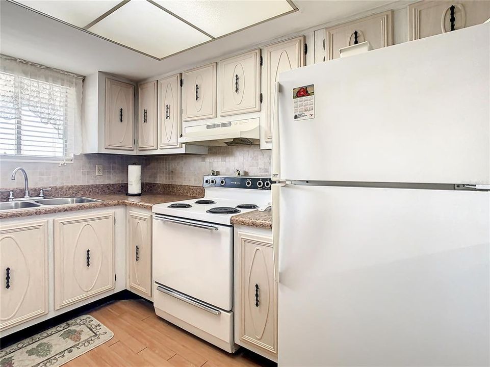 Another look at the refrigerator and range in the kitchen and view of your counter top space
