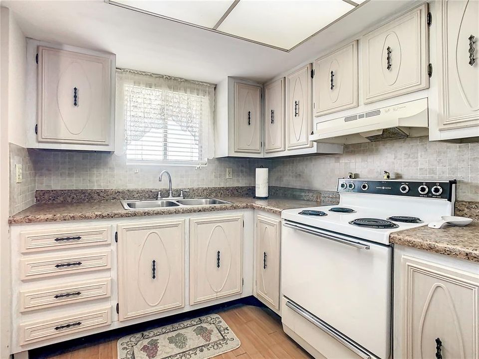 You have a nice sized kitchen with a double sink and lots of cabinets