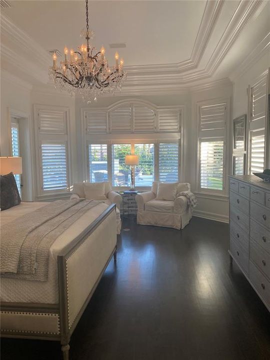 Master Bedroom with Chandelier and View of Outside Oasis and Golf Course