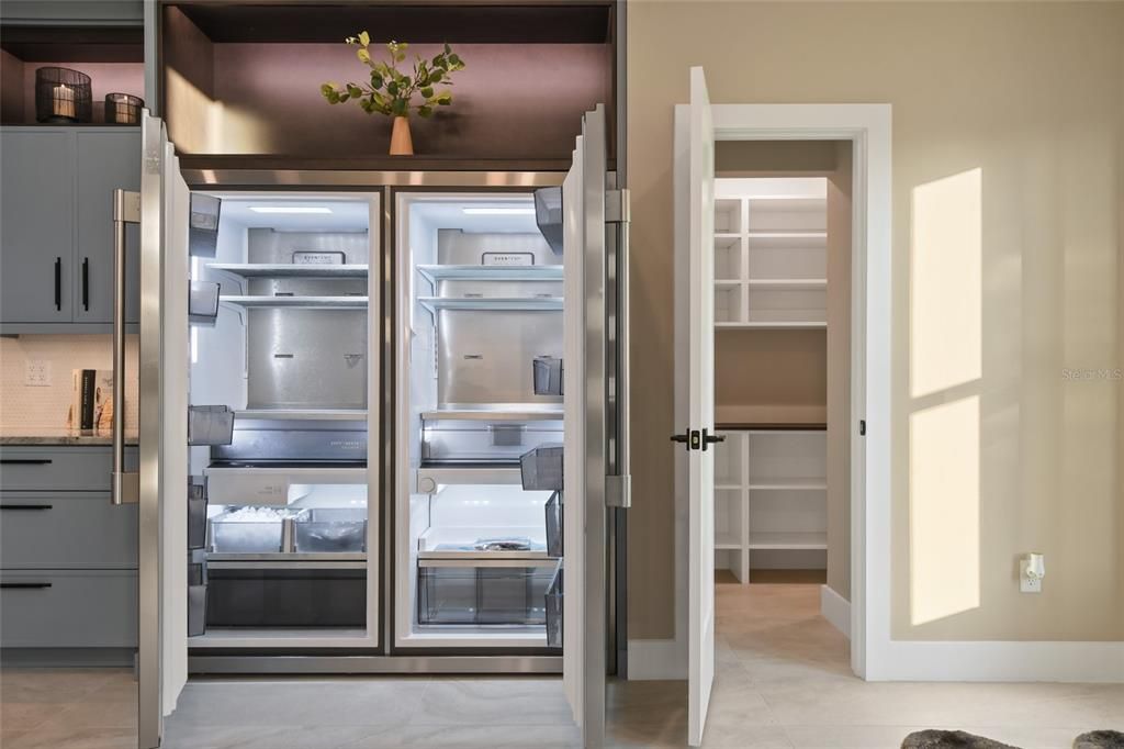 Oversized top of the line refrigerator and custom walk in pantry