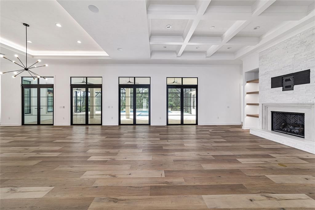 HUGE GREAT ROOM WITH CUSTOM COFFERED CEILING, LUXURY VINYL FLOORING, FIREPLACE WITH STACKED MARBLE STONE - NOT VIRTUALLY STAGED