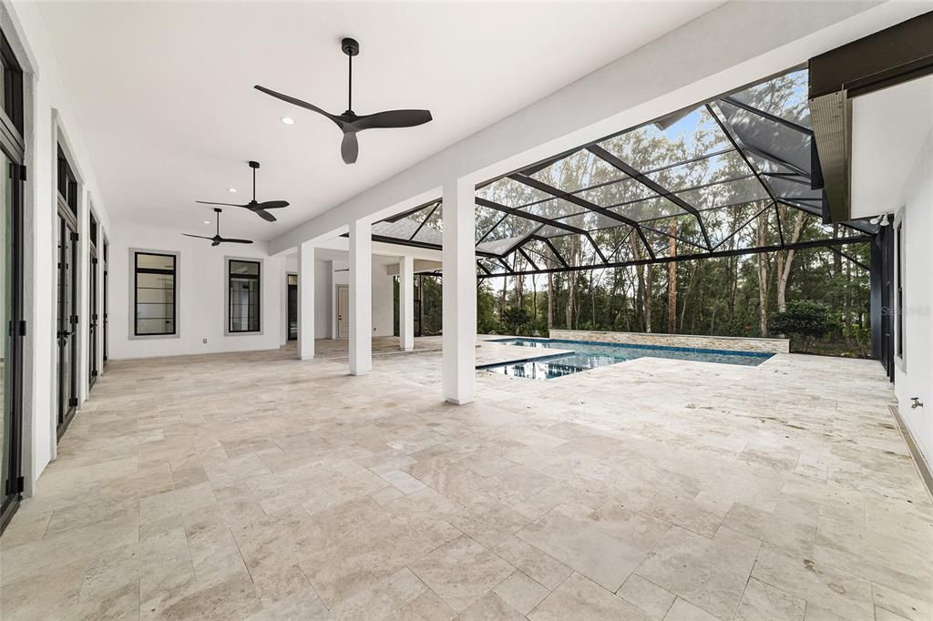 BEAUTIFUL TRAVERTINE PAVERS THROUGHOUT POOL AREA