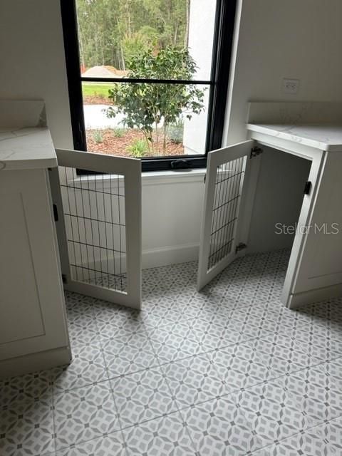 CLOSE UP OF CUSTOM BUILT-IN KENNELS IN LAUNDRY