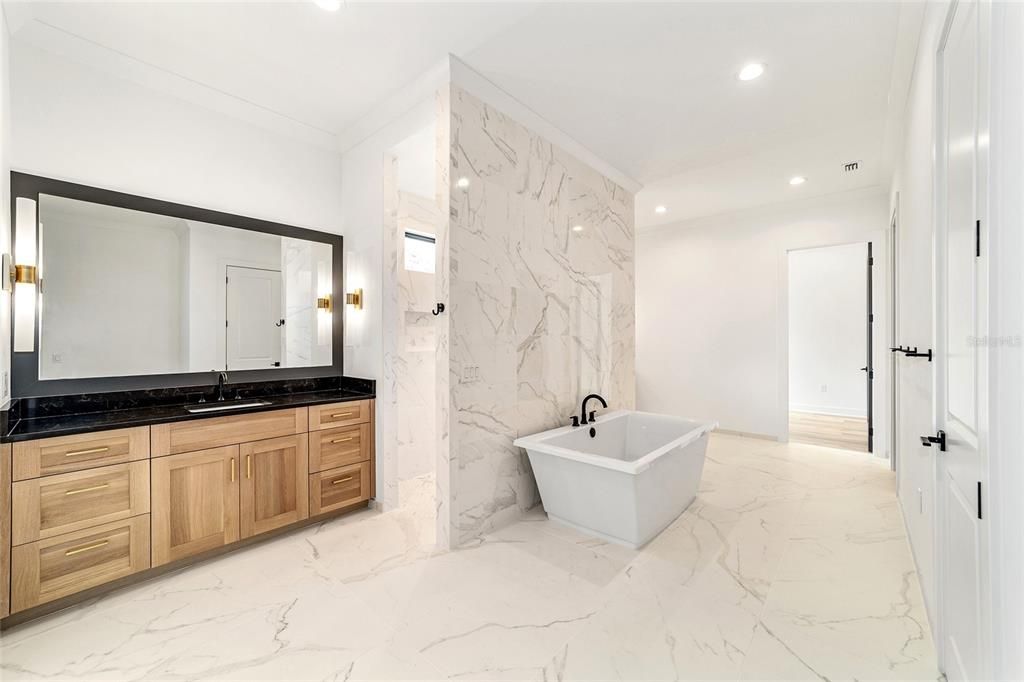 ONE OF TWO EXPANSIVE VANITIES IN OWNER'S BATH; FLOATING SLIPPER TUB