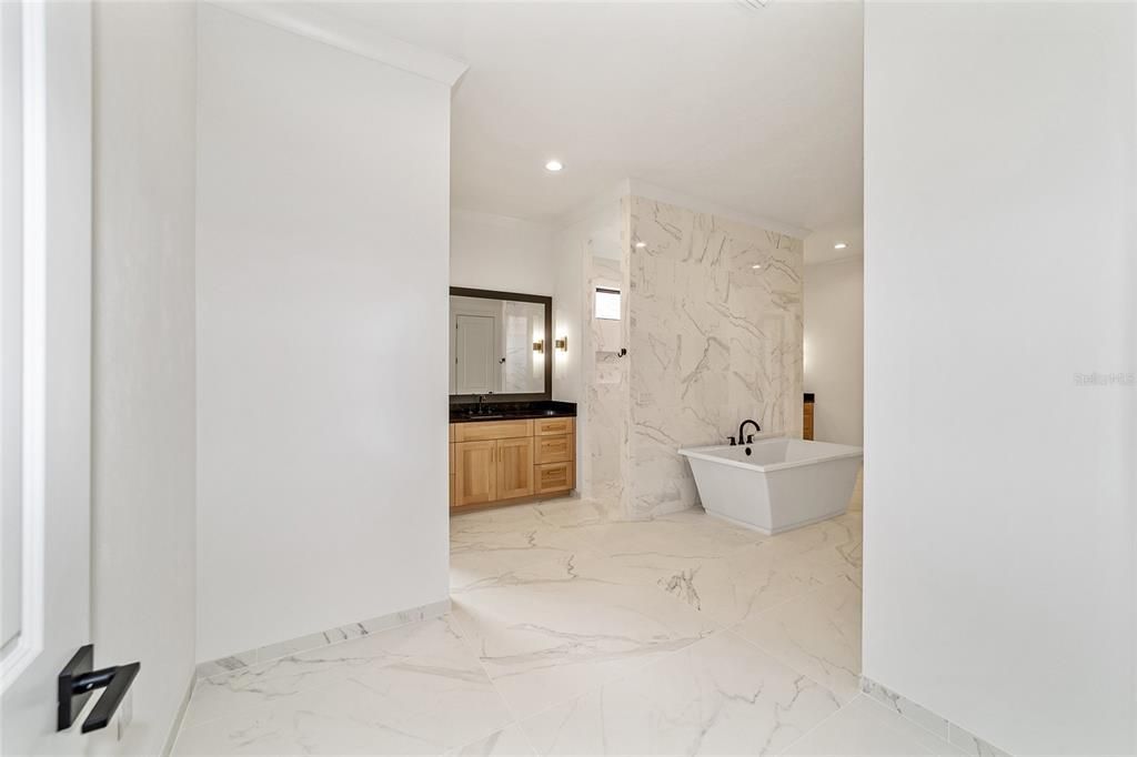 OWNER'S GRAND BATHROOM WITH IMPRESSIVE LARGE SLAB PORCELAN TILE