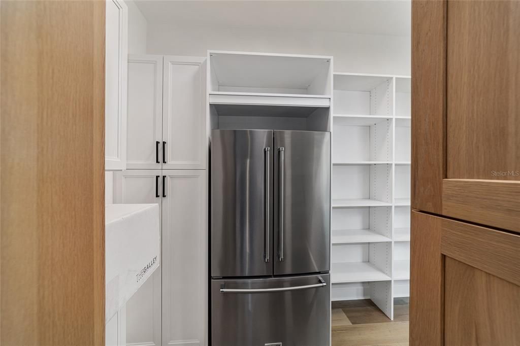 HIDDEN PANTRY HAS SECOND REFRIGERATOR AND AN ABUNDANCE OF STORAGE