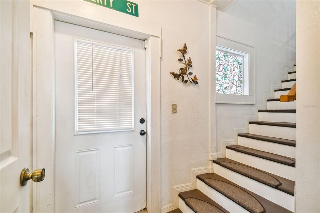 Door to side of house and covered carport