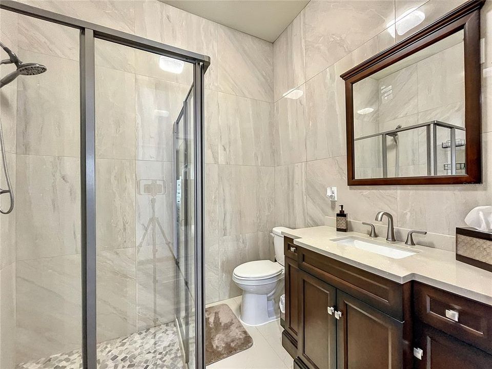 Guest bath inclusive of a walk-in shower.