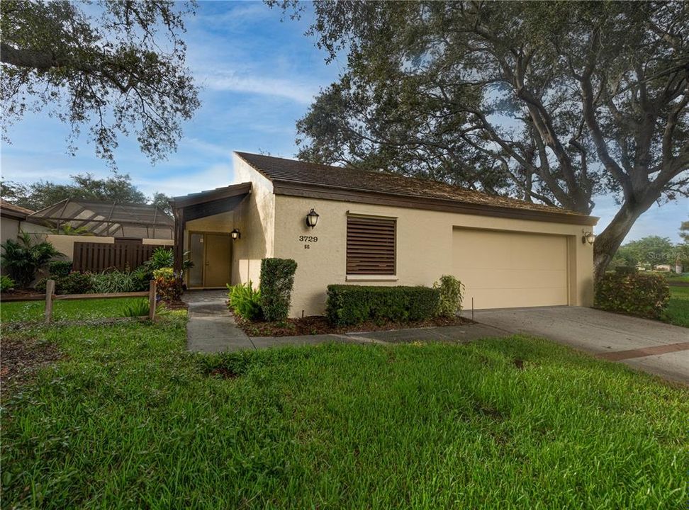 Front of home.  Pool to the left and lake to the right