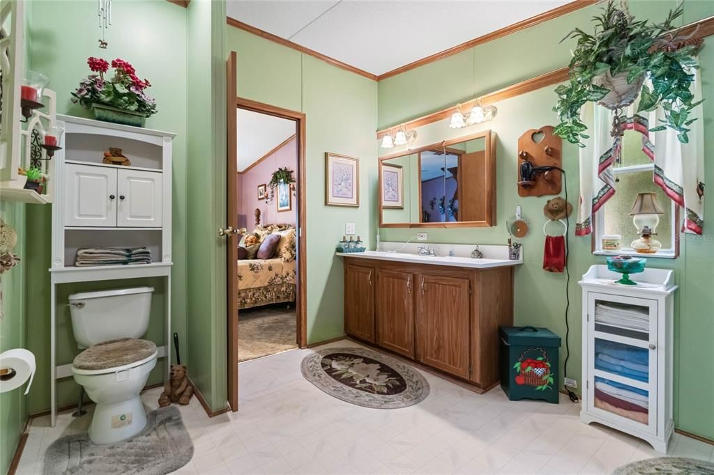 Master bathroom features a linen closet and large vanity