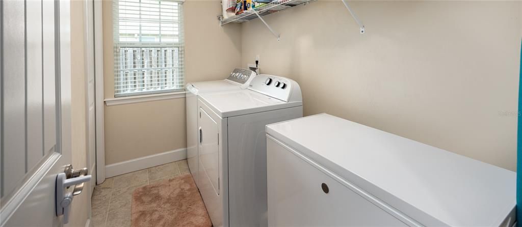 Laundry room off kitchen. It has a storage closet and there's enough room for a freezer. Washer, dryer and freezer do not convey.