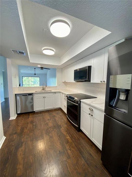 Beautifully remodeled kitchen with solid countertop and a timeless design.