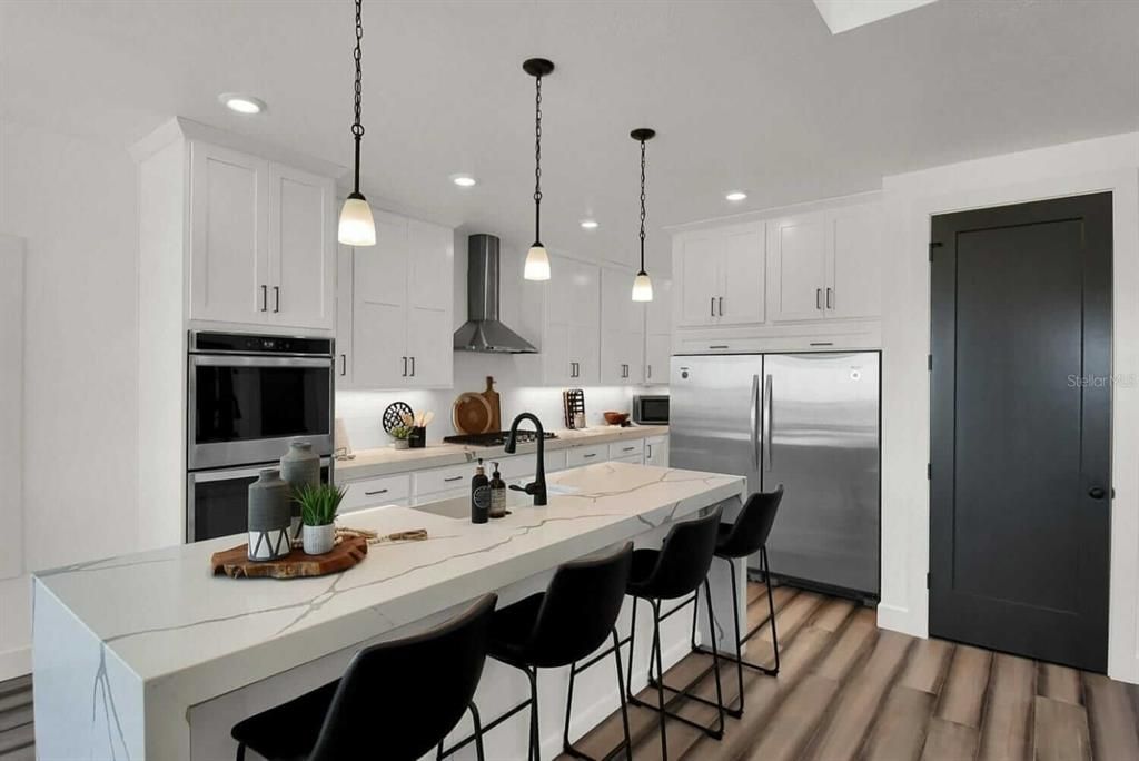 Kitchen. Stools, and Accessories Shown are not Included. Counter Tops, Appliances, Cabinets, Fixtures and other Features and Finishes Shown May Vary. All details to be discussed and concluded at Builder Meeting.