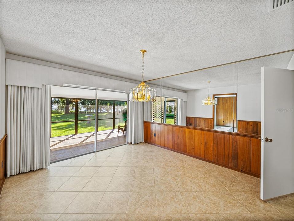 Dining room with view of covered lanai and Lake Hamilton
