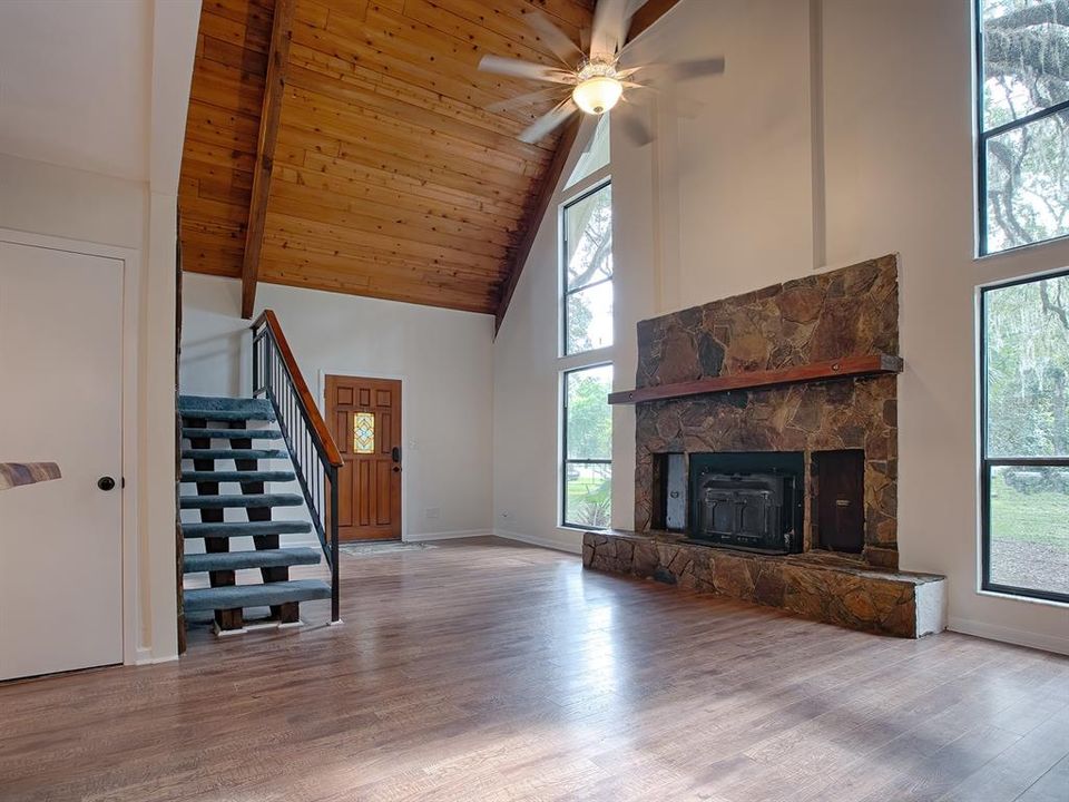 BEAUTIFUL HIGH CEILING, A FIREPLACE AND PLENTY OF NATURAL LIGHT COMING IN FROM THE WINDOWS WITH A VIEW TO THE NATURE THAT SURROUNDS YOU HERE!