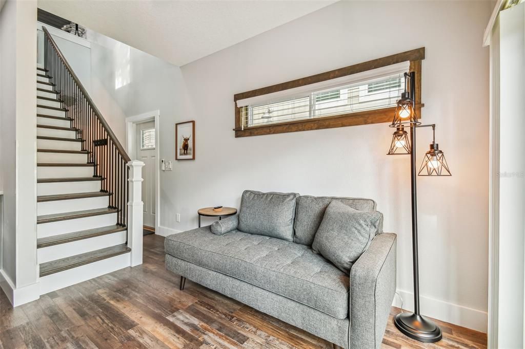 Comfy Sofa in Living Area/ Regular size stairs with Railing lead up to Loft & Upper Deck