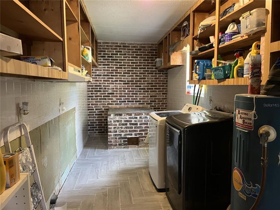 Laundry room with brick smoker