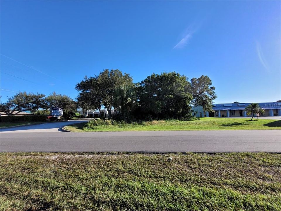 Front view of lot. Businesses on both sides.