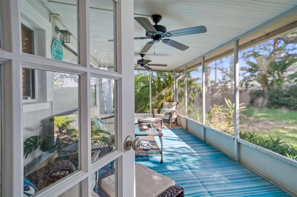 Inviting screened porch with ceiling fans